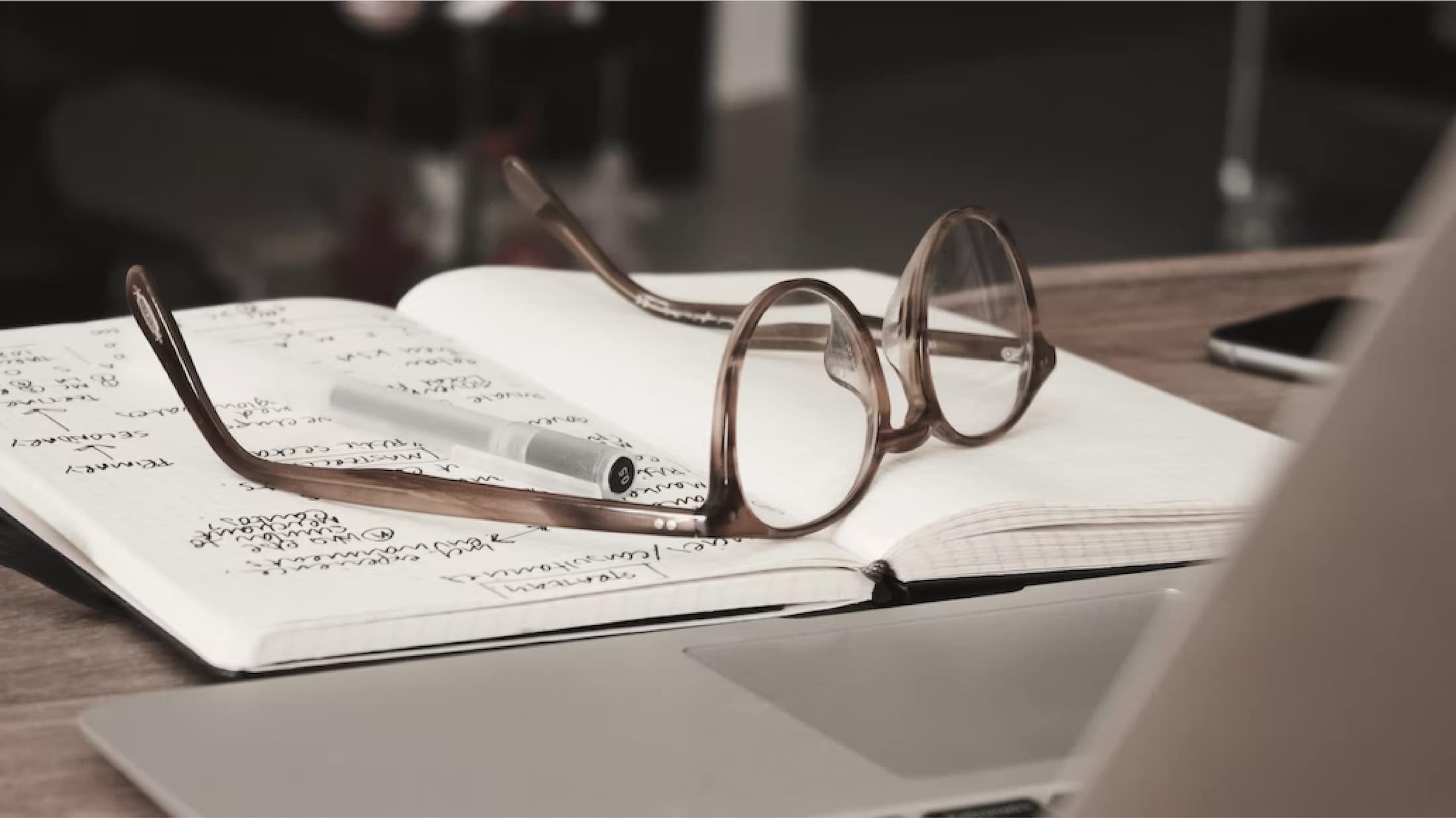eyeglasses on top of open notebook